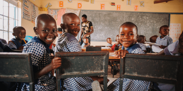 Beaming faces of students in a school funded by donations.