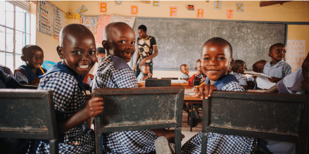 Bright faces of students in a school funded by donations.